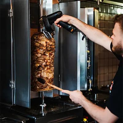 Traditional döner kebab being sliced at Kebab Factory